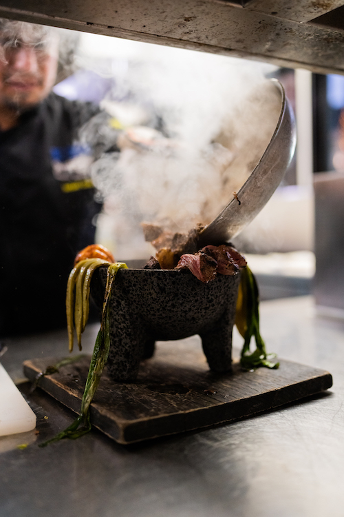 Chef prepping a meat and vegetables