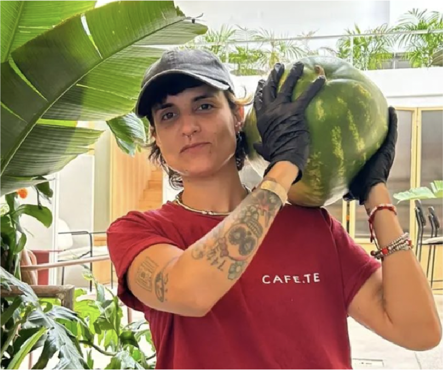 Mercedes Cerouno holding a watermelon on her shoulder.