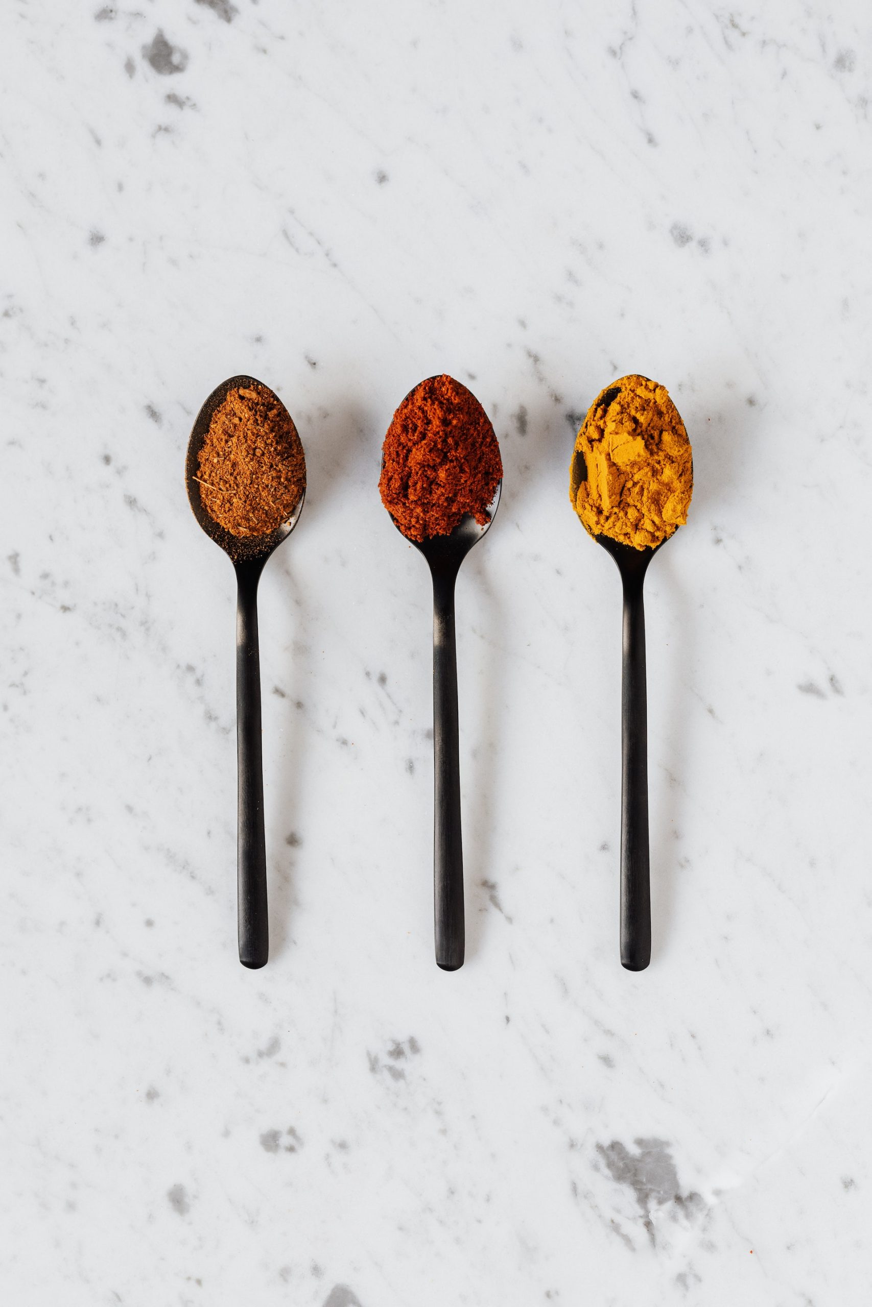 Three spoons with different spices