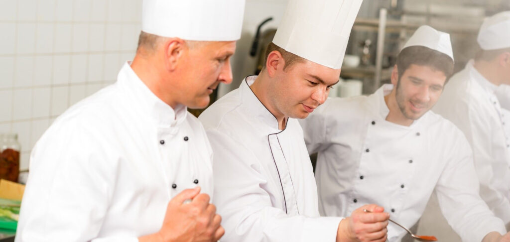 A garde manger and students in the kitchen to illustrate what is the best culinary school