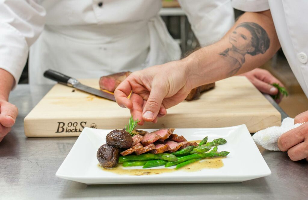 A chef plating a dish to illustrate what skills you need to become a chef.